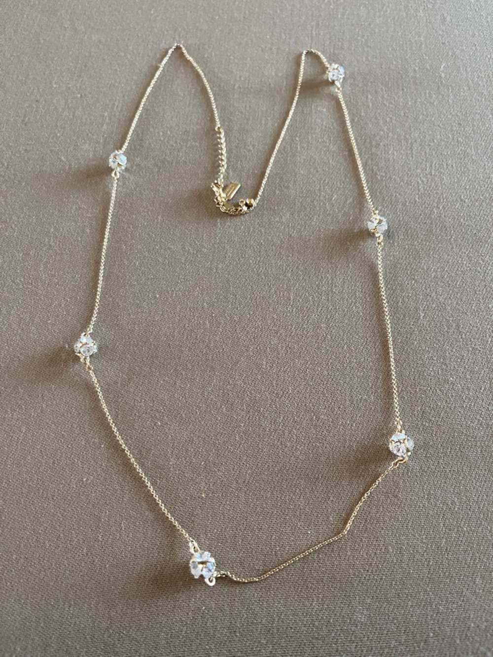 Kate Spade long golden necklace with crystal beads.